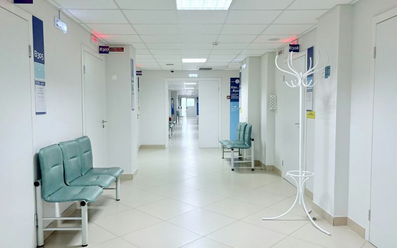 Bright hospital corridor with waiting seats