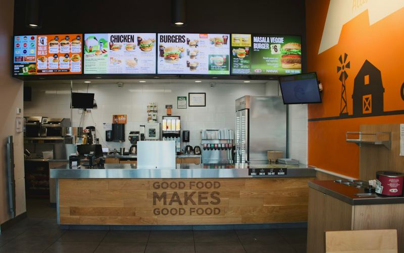 Restaurant counter with digital menu boards above it