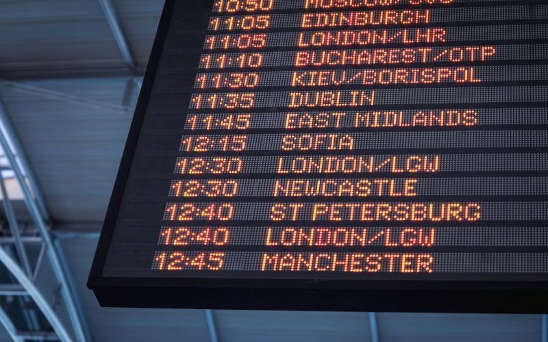 Airport departure board showing flight times